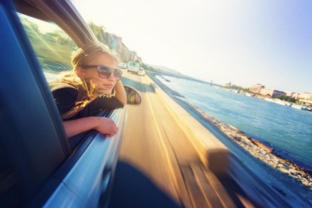 Woman sticking head out of car window